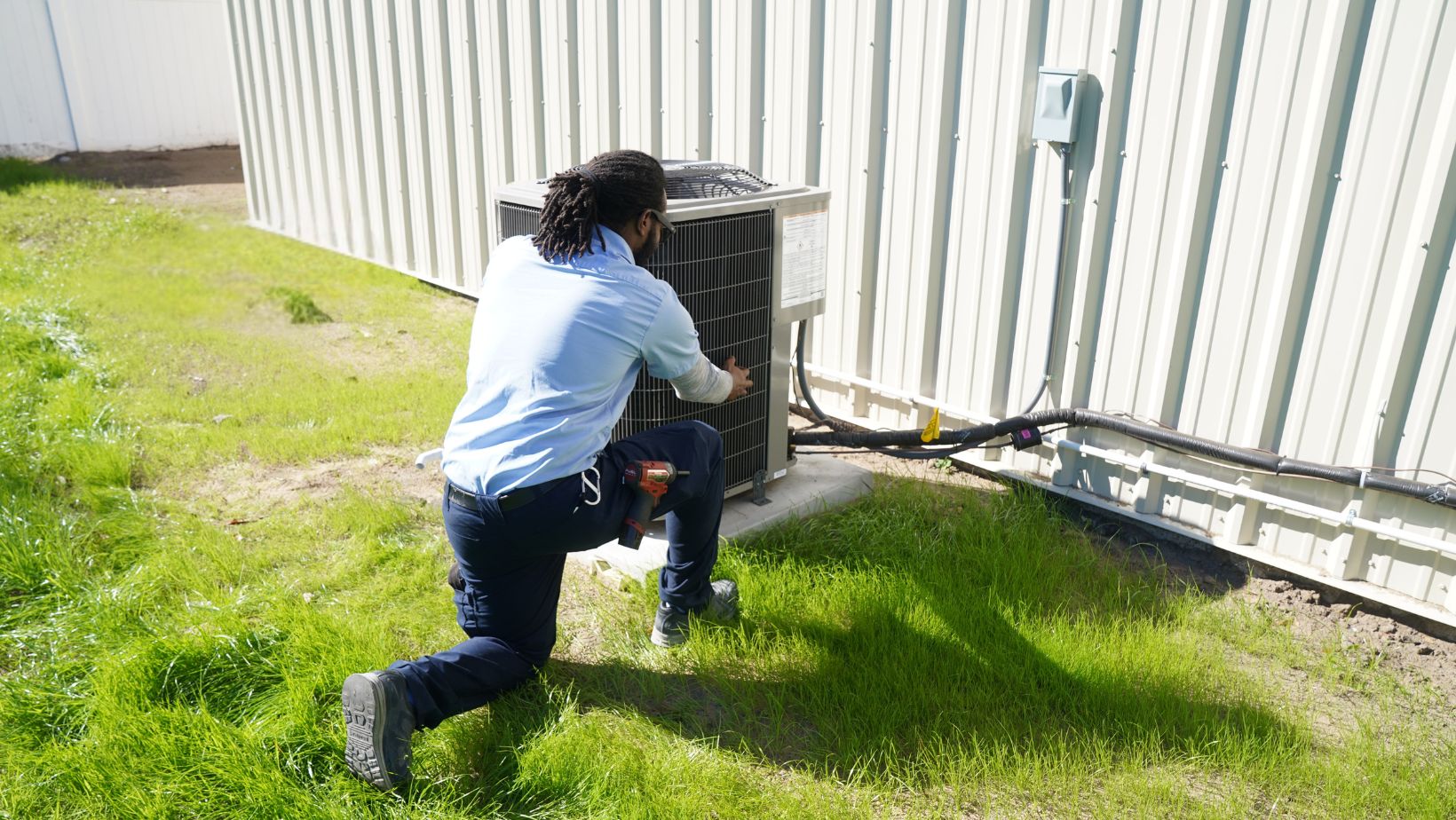 Air conditioning repair services performed by a professional HVAC technician servicing an outdoor AC unit